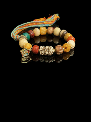 Pangu inspired After the Divide bracelet (12mm) featuring mixed material beads, a colorful tassel cord and gold charm details on a black background