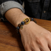Men wearing the After the Flood Gonggong inspired agate bracelet with 10mm beads, styled with a watch for a modern masculine look
