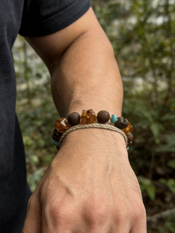 Amber Dawn & Agarwood Earthheart Bracelet – Pangu Edition Outdoor Wear Amber Dawn and Agarwood Earthheart Bracelet Pangu Edition worn on men’s wrist in natural outdoor setting