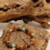 Amber Dawn & Agarwood Earthheart Bracelet – Pangu Edition on Natural Wood Amber Dawn and Agarwood Earthheart Bracelet Pangu Edition displayed on natural wood background symbolizing earth origin energy