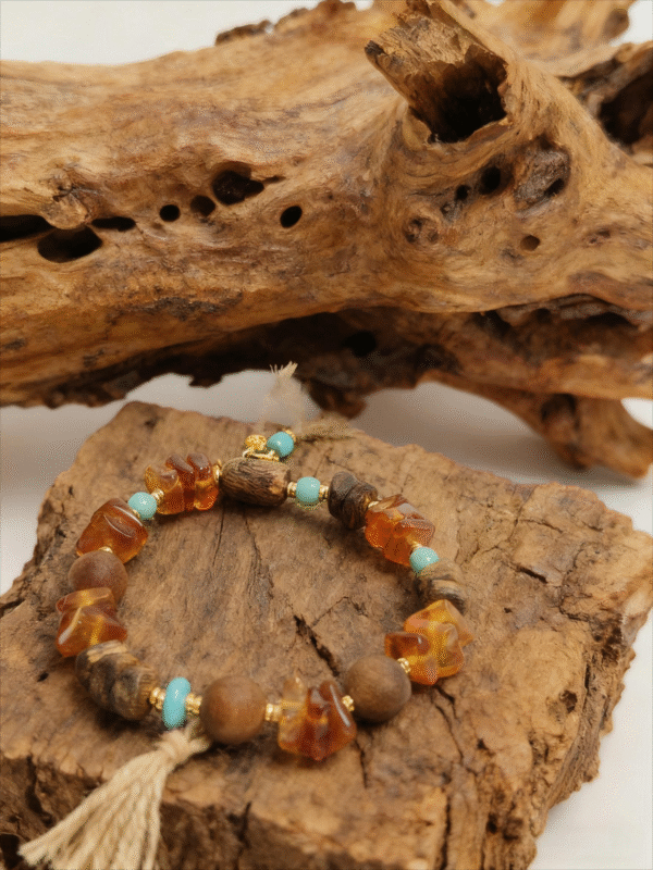 Amber Dawn & Agarwood Earthheart Bracelet – Pangu Edition on Natural Wood Amber Dawn and Agarwood Earthheart Bracelet Pangu Edition displayed on natural wood background symbolizing earth origin energy