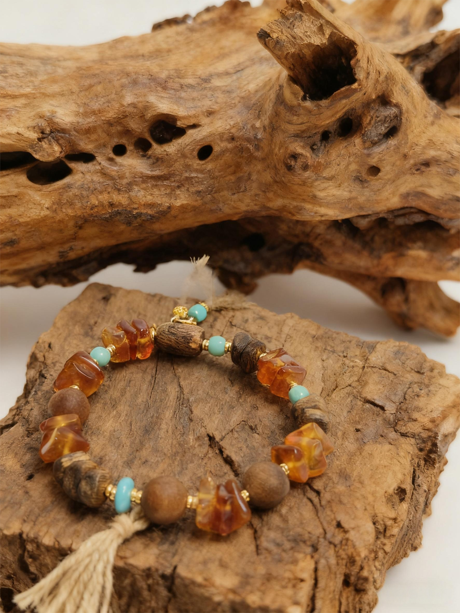 Amber Dawn and Agarwood Earthheart Bracelet Pangu Edition displayed on natural wood background symbolizing earth origin energy