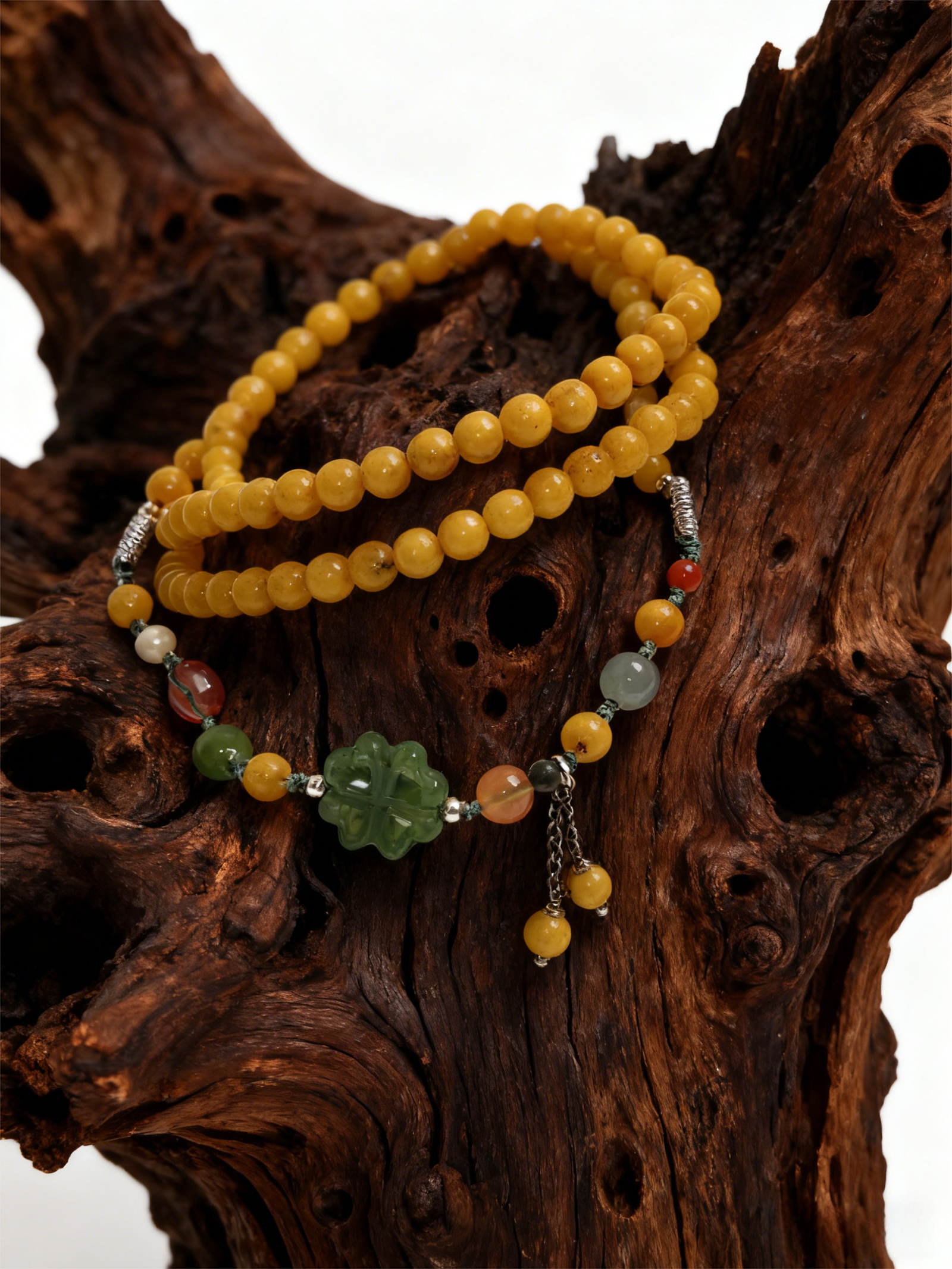 Amber Dawn Genesis Bracelet – Pangu Edition (5mm) with golden amber beads and green jade charm displayed on a natural wooden background