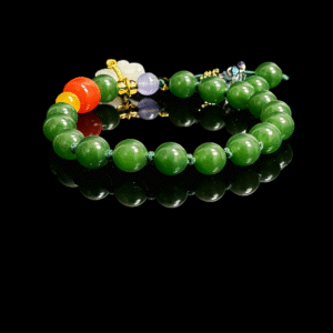 Studio product shot of the Shennong inspired Crimson Herbfruit Jade bracelet, crafted with polished 10mm deep green jade beads, accented by vivid red and golden agate elements, translucent herbal-toned stones, and refined gold spacers, arranged on a glossy black background to highlight the rich luster, natural vitality, and ancient herbal symbolism rooted in Eastern mythology.