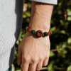 Model wearing the Crimson Seal & Jade Grove Bracelet – Shennong Edition (10mm), showcasing deep green jade beads, red agate highlights, and a carved crimson seal bead, symbolizing vitality, grounding energy, and Shennong’s ancient herbal wisdom