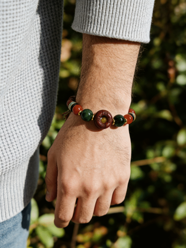 Model wearing the Crimson Seal & Jade Grove Bracelet – Shennong Edition (10mm), showcasing deep green jade beads, red agate highlights, and a carved crimson seal bead, symbolizing vitality, grounding energy, and Shennong’s ancient herbal wisdom