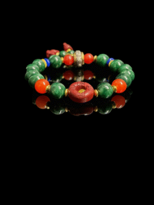 Crimson Seal & Jade Grove Bracelet featuring 10mm green jade beads, a carved crimson seal centerpiece with symbolic markings, and gold spacer accents, inspired by Shennong mythology and traditional herbal wisdom