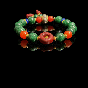 Crimson Seal & Jade Grove Bracelet featuring 10mm green jade beads, a carved crimson seal centerpiece with symbolic markings, and gold spacer accents, inspired by Shennong mythology and traditional herbal wisdom