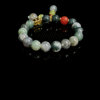 Field Apothecary Bracelet – Shennong Inspired (10mm) featuring green moss agate beads with natural marbling and herbal earth-tone accents on a black background