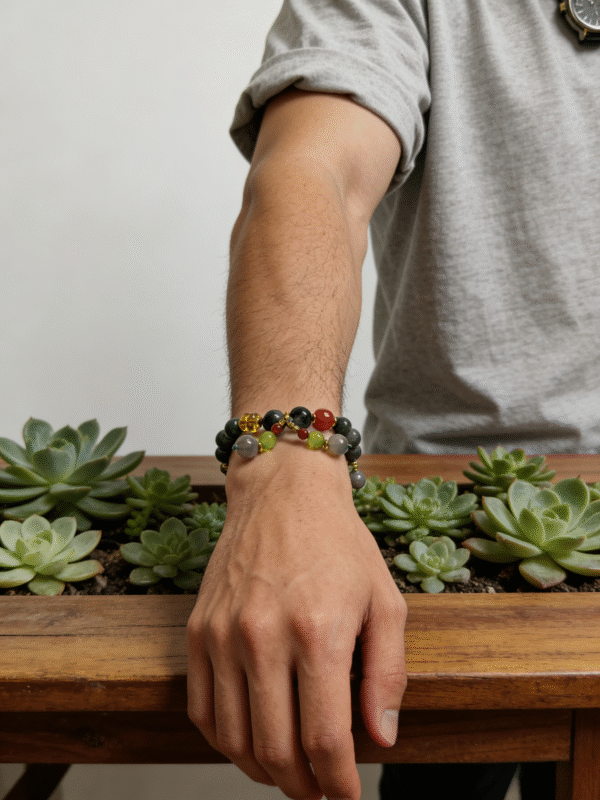 Model wearing the Field Apothecary Bracelet inspired by Shennong, featuring green agate and multicolor natural stones, shown on wrist in a natural indoor setting.