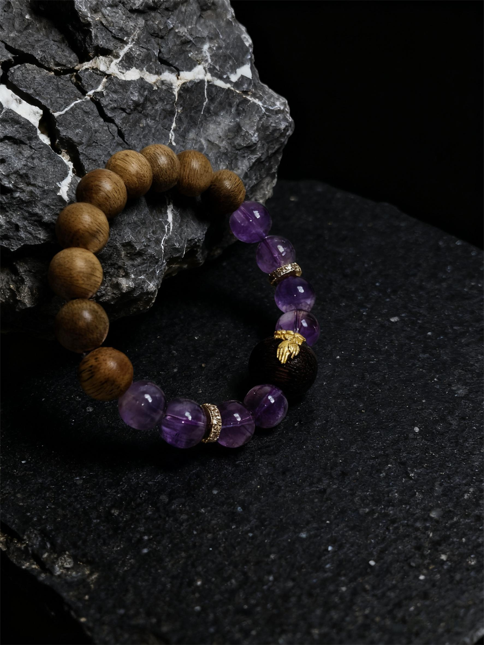 Full view of the Nüwa inspired Mother of Earth bracelet (11mm) with purple translucent beads and natural wood beads on a dark stone background