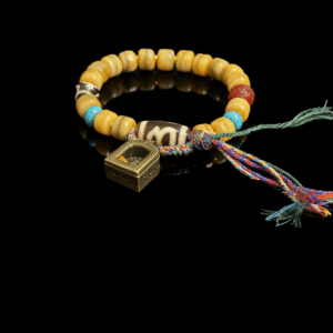 Product view of the Pangu’s Primordial Ethereal Bone-Agate Bracelet (10mm), featuring bone-tone agate beads, a colorful braided tassel cord and a geometric gold charm on a black background
