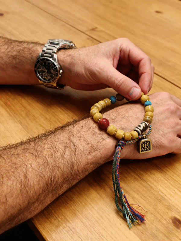 Pangu’s Primordial Ethereal Bone-Agate Bracelet worn outdoors, paired with steel watch, emphasizing natural texture and handcrafted design