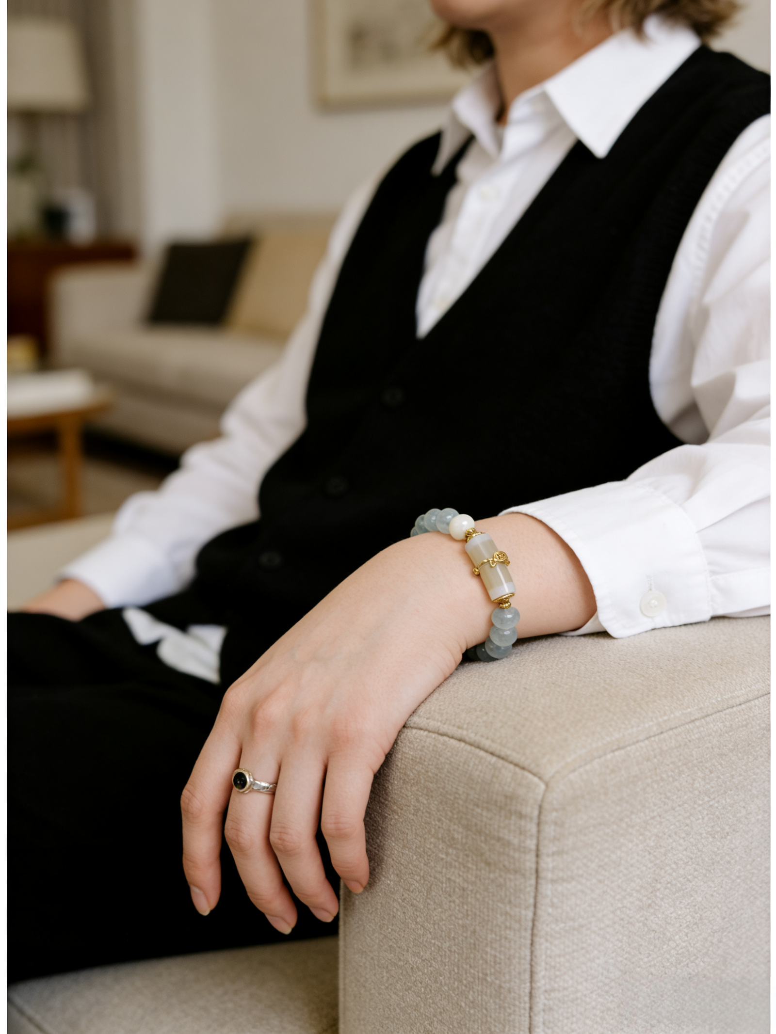 Model wearing the Quiet Oath Aquamarine Bracelet inspired by Jingwei, featuring soft blue aquamarine beads and a minimalist, calm, and resilient design