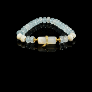 Product photo of the Jingwei inspired Quiet Oath aquamarine bracelet (6mm) with light blue beads, white accents and gold details on a black background