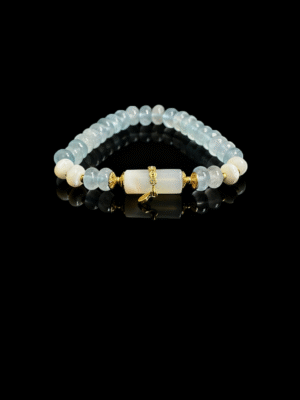 Product photo of the Jingwei inspired Quiet Oath aquamarine bracelet (6mm) with light blue beads, white accents and gold details on a black background
