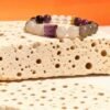 Settled Order Bracelet – Nüwa Inspired on Stone Display Settled Order Bracelet inspired by Nüwa, featuring purple agate centerpiece and translucent gemstone beads, displayed on textured stone against a warm orange background