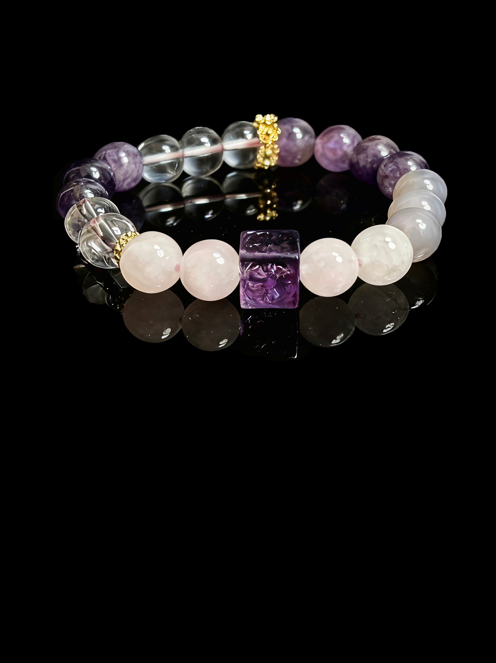 Settled Order Bracelet inspired by Nüwa, featuring amethyst, rose quartz, and clear crystal beads with gold accents, symbolizing balance and harmony