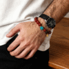 Man wearing the Xingtian inspired Steadfast Heart red agate bracelet (10mm) with turquoise center stone and gold charm styled with a watch