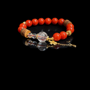 Unbroken Core red agate bracelet inspired by Xingtian, featuring 10mm natural red agate beads with clear quartz and gold accents on a black background