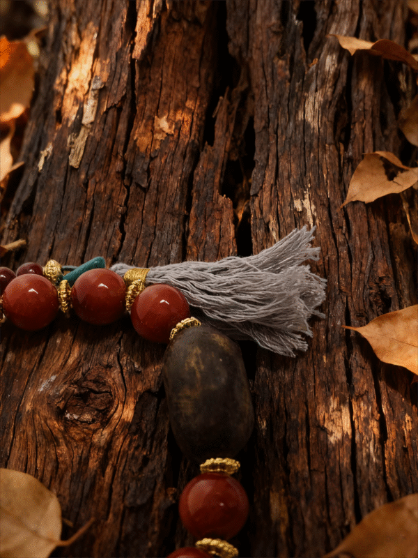 Detail of Agarwood War-Totem Agate Bracelet Xingtian Edition 10mm with natural wood texture and tassel