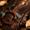 Agarwood War-Totem Agate Bracelet Xingtian Edition 10mm photographed on natural wood background handmade spiritual jewelry