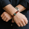 Men wearing Bound Resolve Red Agate Bracelet Xingtian Inspired 10mm with turquoise centerpiece and tassel charm