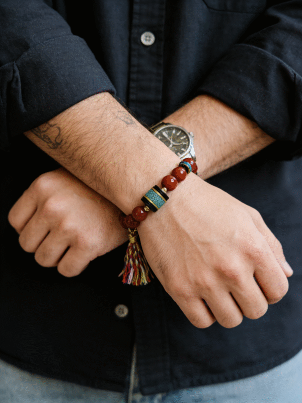 Men wearing Bound Resolve Red Agate Bracelet Xingtian Inspired 10mm with turquoise centerpiece and tassel charm