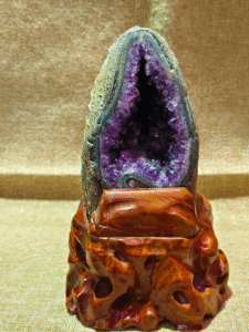 natural mineral collectible titled Amethyst Inner Flame, featuring a deep purple amethyst crystal cavity with sparkling inner formations displayed on a carved base