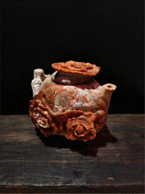 hand-carved stone collectible titled Blooming Prosperity Teapot, featuring a teapot form adorned with blooming floral motifs carved from natural stone