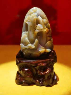 hand-carved stone collectible titled Eternal Pine Mountain, depicting pine-inspired forms rising from a mountain-shaped composition on a carved base