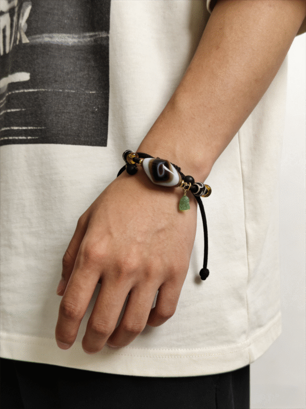 Handcrafted turbulent agate bracelet with dzi bead shown on wrist