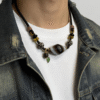 Model wearing Gonggong inspired turbulent layered agate and dzi necklace on neck