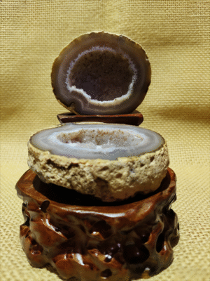 natural mineral collectible titled Inner Cosmos, featuring a sliced geode with an exposed crystal interior displayed on a carved stand