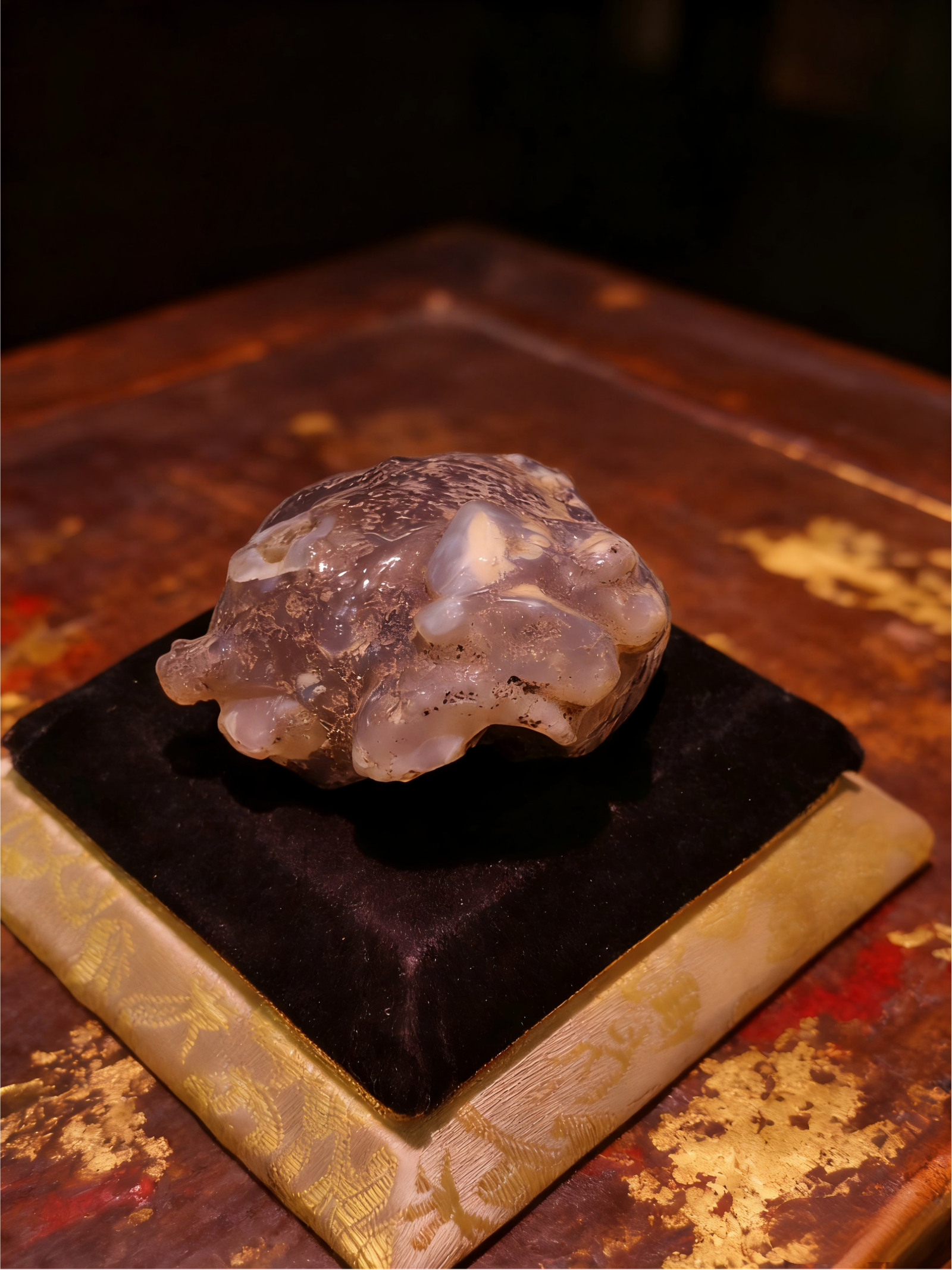 Handheld Agate Artwork titled Stone Sentinel, featuring a compact, guardian-like stone form displayed on a padded stand