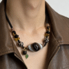 Close-up of natural agate dzi centerpiece on black cord necklace