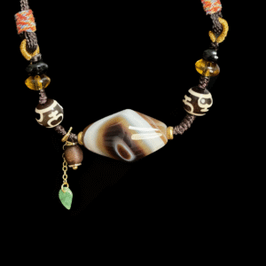 Turbulent Layered Agate & Dzi pendant necklace featuring a central layered agate bead, traditional Dzi beads, amber accents, and hand-knotted cord, inspired by Gonggong mythology