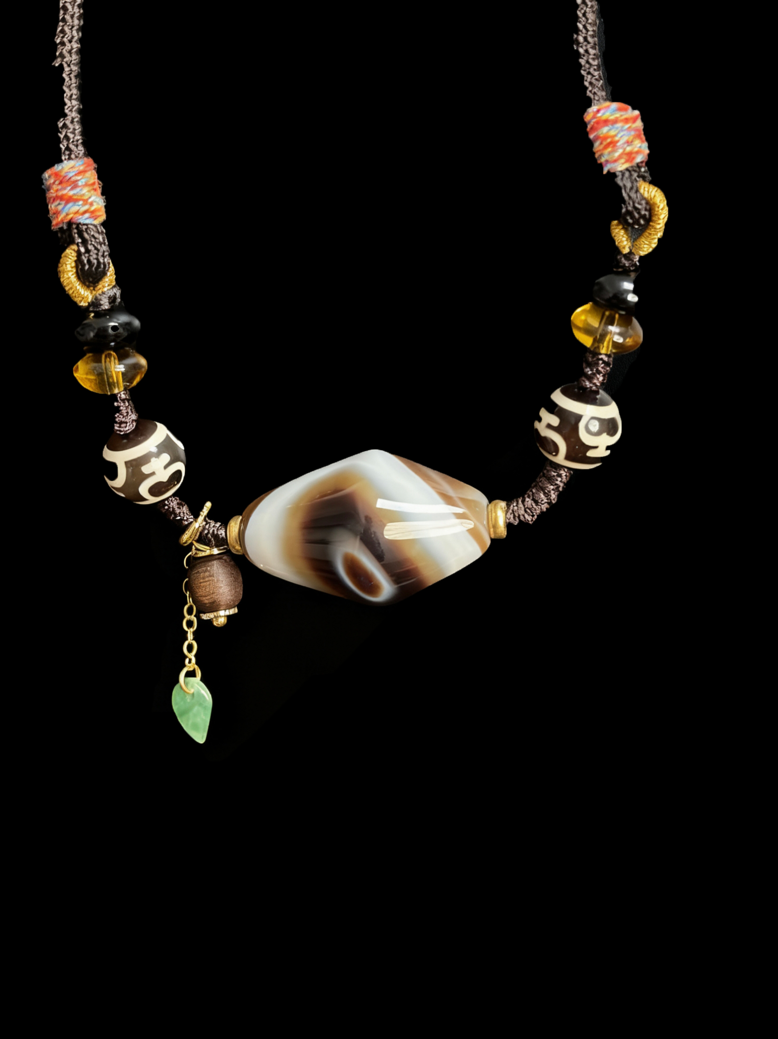 Turbulent Layered Agate & Dzi pendant necklace featuring a central layered agate bead, traditional Dzi beads, amber accents, and hand-knotted cord, inspired by Gonggong mythology