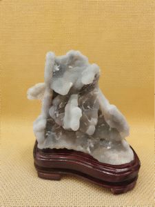 natural mineral collectible titled Cloudstone Peak, featuring layered cloud-like stone formations rising in a mountain-like structure