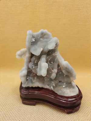 natural mineral collectible titled Cloudstone Peak, featuring layered cloud-like stone formations rising in a mountain-like structure
