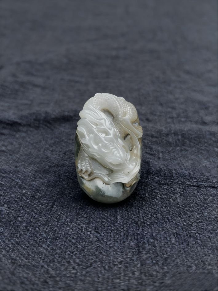 handheld agate artwork titled Ivory Coil Dragon, carved from natural agate stone as a coiled dragon collectible sculpture