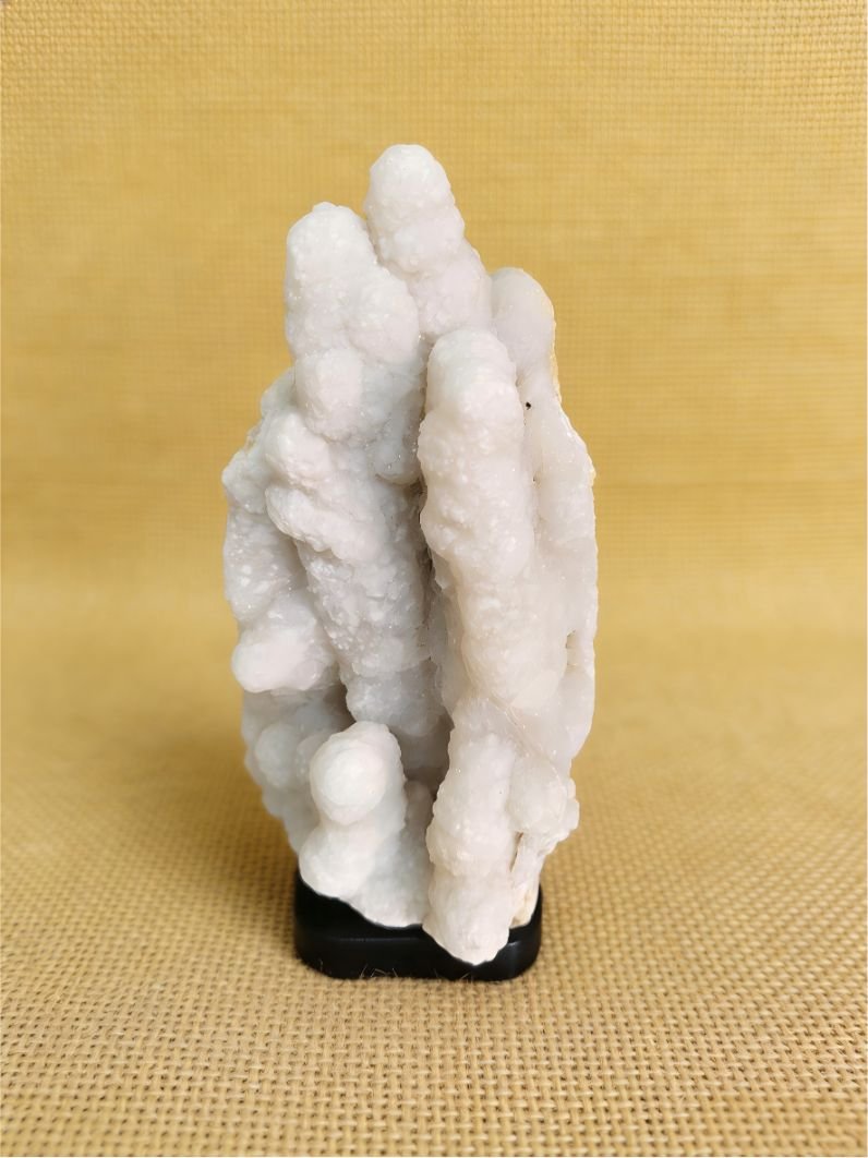 natural mineral collectible titled Twin Snow Pillars, featuring two vertical white stone formations rising like snow-covered columns