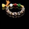 Gonggong’s Turbulent Elements Dzi Bead Bracelet with Agate, Jade & Beeswax Amber(12mm) Gonggong-inspired beaded bracelet featuring Dzi beads, agate, jade, beeswax amber, and multicolored woven cord.